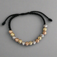 Pulsera tejida con balines diamantados de 3 oros en oro 18K tamaño #6, diseño elegante y artesanal, ideal para regalar o uso diario.