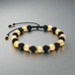 Pulsera tejida con hilo terlenca y balines grandes diamantados de oro 18K para mujer u hombre, hecha a mano en Colombia.