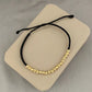Pulsera hecha a mano con hilo terlenca y 19 balines diamantados de oro 18K. Diseño elegante, ideal para regalo o uso diario.