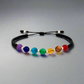 Pulsera tejida con piedras naturales de 7 chakras y balines diamantados de oro 18K hecha a mano en Colombia.
