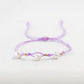 Pulsera de hilo lila con 3 balines de oro 18k - Brillo Encanto